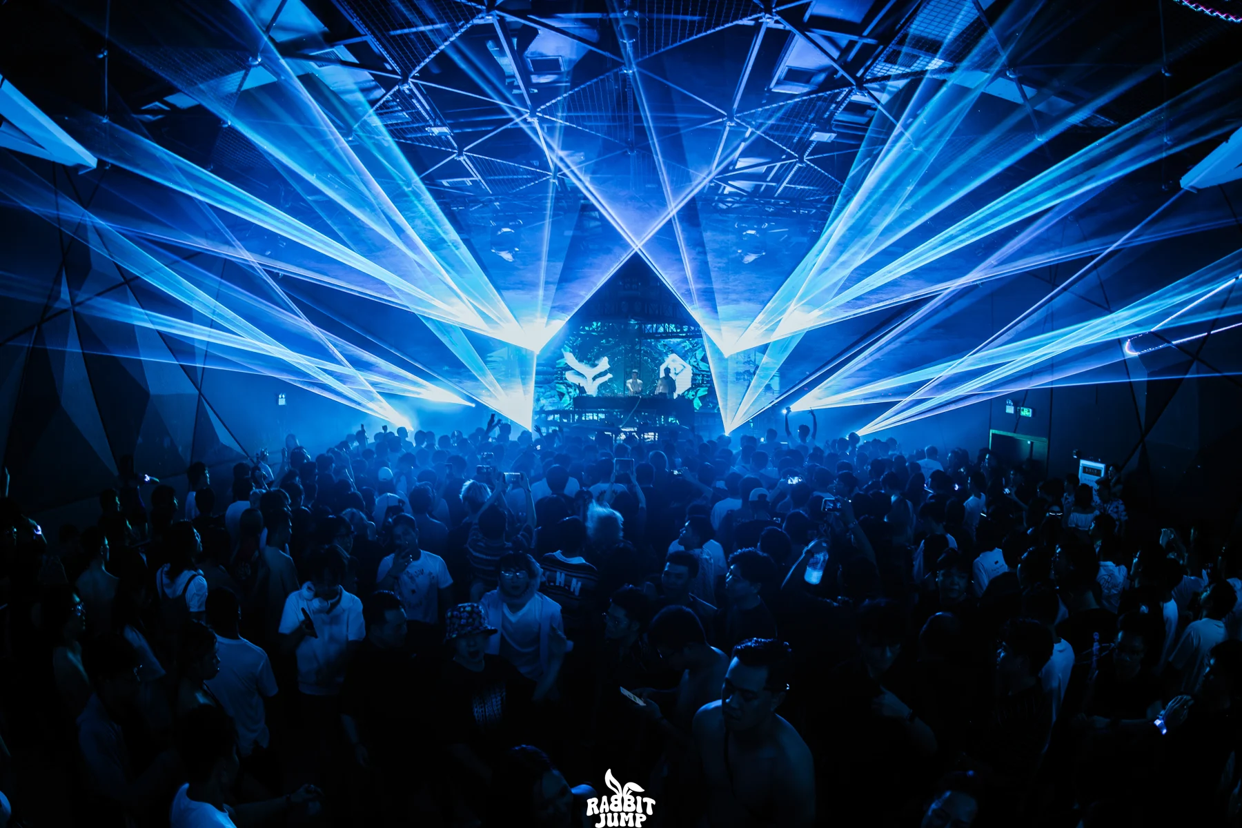 Blue LASERLAB beams crossing above the Rabbit Jump crowd